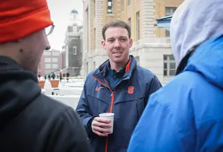 Assistant coach Gerry McNamara talks to students who are camping out by the Carrier Dome. McNamara talked to campers while giving out hot chocolate.