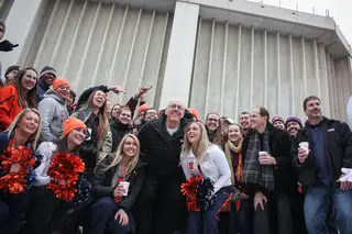 Jim Boeheim poses with SU cheerleaders, campers and fans outside of the Carrier Dome.
