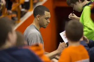 Tyler Ennis signs autographs for young fans, calm and collected before the biggest game of his young collegiate career. 