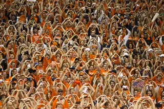 Fans form their hands into 'O's during the singing of the national anthem.