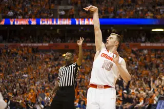 Trevor Cooney holds his follow-through on a 3-point attempt. 