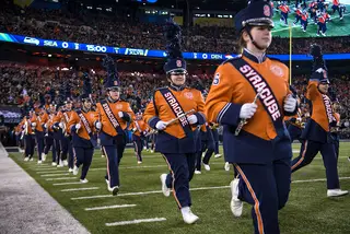 SUMB members sprint onto the field at MetLife Stadium on Sunday evening. They accompanied the Rutgers Marching Band for the Super Bowl pregame show.