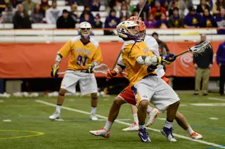An Albany attacker prepares to shoot the ball over his shoulder, scoring a point for Albany.