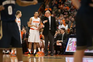 Syracuse head coach Jim Boeheim gives instructions to his backcourt players, Tyler Ennis and Trevor Cooney.