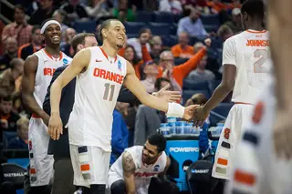 Ennis congratules freshman B.J. Johnson during Syracuse's second-round victory as Fair smiles in the background.