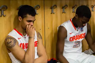 Gbinije (left) and Roberson (right) remain silent in the locker room after the game. 