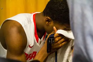 Fair cries into a towel after playing in his final college game. 