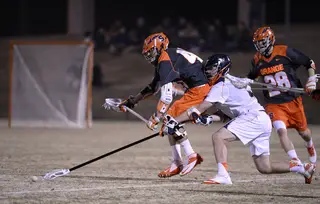 Syracuse and Virginia fight for a ground ball in the midfield. 