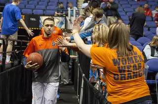 Tyler Ennis leads the Orange onto the court and interacts with a row of Syracuse fans. 
