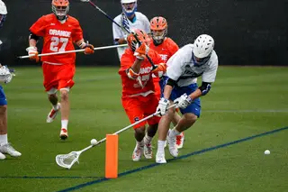 A Blue Devils pole tip toes the sideline and tries to collect a groundball. 