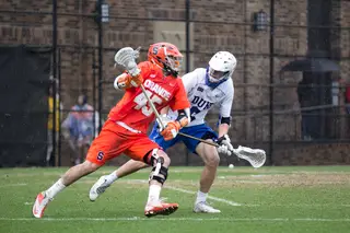 Syracuse's Randy Staats dodges toward the net as a Duke defender obstructs his path. Staats was a rare bright spot for the Orange in the game, netting two highlight-reel goals. 