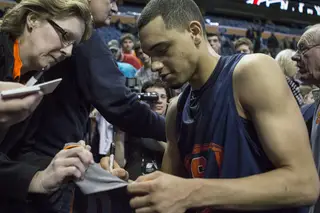 Freshman point guard Tyler Ennis signs an autograph for a Syracuse fan. Ennis, like Fair and Keita, could be playing his last game Thursday if he decides to declare for the 2014 NBA Draft.