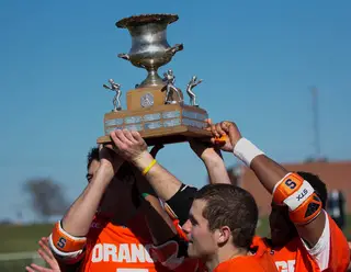 Syracuse hoists the Kraus-Simmons Trophy, a staple of the Syracuse-Hobart rivalry.