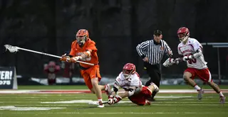 A Syracuse defender recovers a bad Cornell pass as two Cornell attacks try to regain possession. 