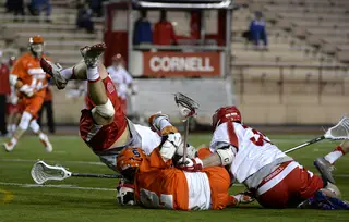 Kevin Rice collides into two Cornell players while fighting for the ball. 