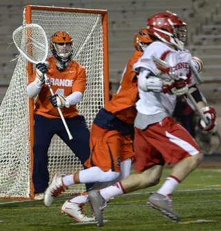 Wardwell guards the right side of the goal as a Cornell attacker tries to get around a Syracuse defender. 