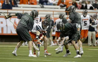 A crowd of players vie for a groundball. Syracuse barely won the groundball battle, collecting 28 to the Bearcats' 24. 