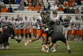 A Syracuse and Binghamton player collide in a crowd of players. 