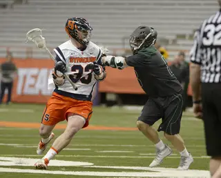 Scott Loy moves toward the net while a defender obstructs his path. Loy scored the decisive goal in third quarter that gave SU a 7-6 lead that it wouldn't give up. 