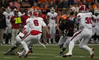 Gulley carries the ball and attacks a trio of Wolfpack defensive backs.