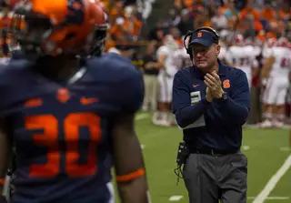 SU head coach Scott Shafer puts his hands together during a break in the action.
