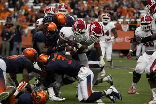 The Syracuse defense comes together to stop NCSU running back Matt Dayes.