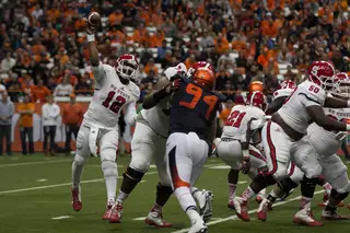 Brissett releases a throw to his right while SU defensive end Robert Welsh takes on offensive lineman Tyson Chandler.