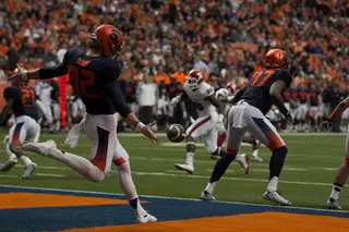 Syracuse punter Riley Dixon boots a punt from the Orange's end zone.