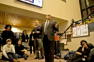 Tony Callisto, Department of Public Safety chief, speaks with DAT Rally protesters in the Crouse-Hinds Hall lobby after student organizers met with senior administrators. 