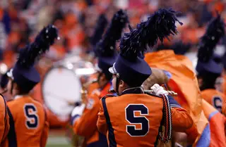 The Syracuse Marching Band performs on the field during halftime. 