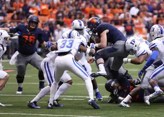 Gulley finds himself on the ground as Syracuse quarterback Mitch Kimble is jammed at the line. 