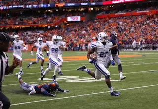 A Syracuse player hits the ground hard, in a last-gasp attempt to prevent a Duke touchdown. 