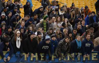 The Panthers' student section cheers on its team through cold and rainy conditions.
