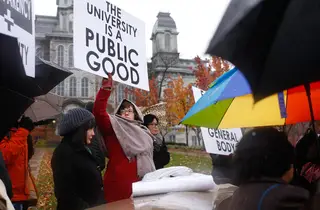 Jessica Posner, a VPA transmedia part time professor holds up a sign during a protest in support of THE General Body.