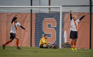 Syracuse's Nick Perea (left) and Emil Ekblom (right) celebrate after Penn State goalie Andrew Wolverton brought the ball over the goal line for SU's second goal of the game.