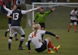 Ekblom picks himself up off the ground as Penn State's Mike Robinson throws his hands up and looks at an official.