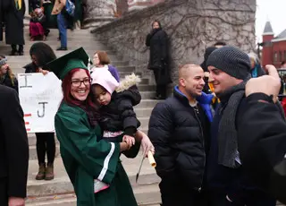 Emily Benazzi, a class of 2014 environmental education and interpretation graduate, poses with her niece, Bella Benazzi, outside of Hendricks Chapel. The SUNY-ESF graduation ceremony time coincided with the time of the rally.