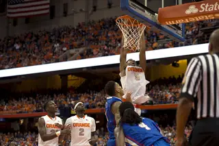 Freshman forward Chris McCullough rises for a dunk over Kyser while Johnson and Tyler Roberson look on.