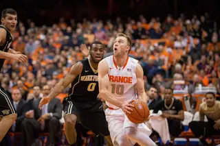 Trevor Cooney drives to the basket with Codi Miller-McIntyre (0) on his back. The SU junior guard had 13 first-half points.