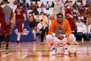 Rakeem Christmas crouches near midcourt before the Syracuse team he's been carrying takes on Boston College on Tuesday night.