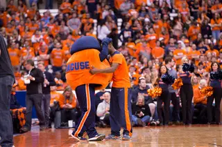 Otto the Orange hugs a Syracuse cheerleader on the court before the game.