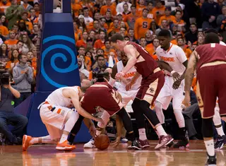 Guard Trevor Cooney scraps for a loose ball with a BC player as Christmas and B.J. Johnson look on.