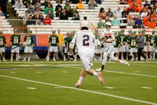 Faceoff specialist Ben Williams fires a pass to SU attack Kevin Rice.