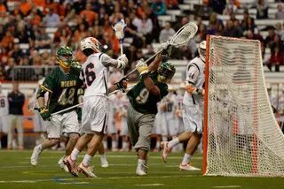 Ryan Simmons pressures Siena from the side of the goal as the Saints' Nick Capalbo tries to make a save. Simmons scored two goals for SU in the Orange's 21-7 win.