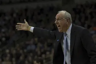 Boeheim, the SU head coach, extends his right arm while yelling toward the court.