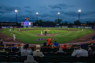 Fans watch the Syracuse Mets play the Scranton/Wilkes-Barre Railriders on opening day.