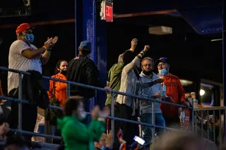 Fans cheer from the stands during the Syracuse Mets opening day game.