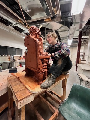 Katie Stone, a graduate student at Syracuse University, works on their sculptures and pieces in the Comstock Art Facility on campus. Much of their art explores the concept of gender and ‘silent power’ of women. 
