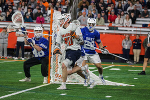 Syracuse's Cole Kirst navigates his way toward the middle from behind the cage. Kirst recorded his third consecutive hat trick but it wasn't enough in Syracuse's 18-15 loss to Duke