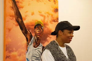 Megan Lewis stands in front of her painting “Joy” at her first artist talk at the Community Folk Art Center.
